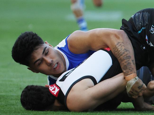 ADELAIDE, AUSTRALIA - APRIL 26: Josh Sinn of the Power is tackled by Paul Curtis of the Kangaroos during the 2025 AFL Round 07 match between the Port Adelaide Power and the North Melbourne Kangaroos at Adelaide Oval on April 26, 2025 in Adelaide, Australia. (Photo by James Elsby/AFL Photos via Getty Images)