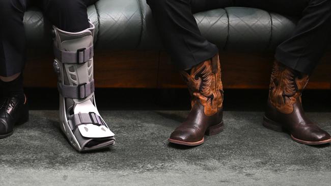 Mr Joyce with his new cowboy boots (right) next to Banks MP David Coleman’s slightly less stylish moon boot. Picture: AAP Image