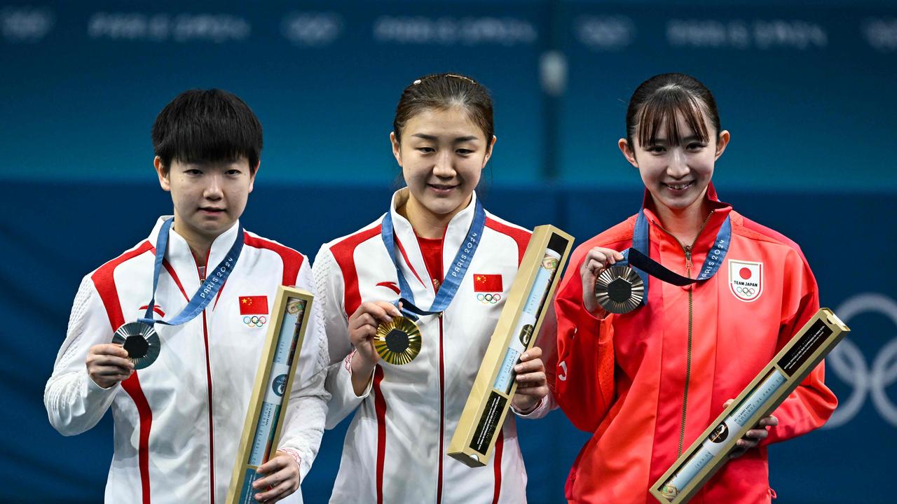 Silver medallist China's Sun Yingsha, Gold medallist China's Chen Meng and Bronze medallist Japan's Hina Hayata celebrate on the podium after the women's table tennis singles gold medal match at the Paris 2024 Olympic Games at the South Paris Arena in Paris on August 3. Picture: AFP