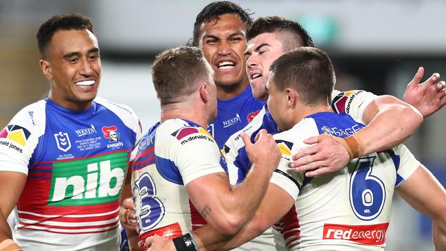 GOLD COAST, AUSTRALIA - AUGUST 21: Jake Clifford of the Knights celebrates scoring a try with team mates during the round 23 NRL match between the Canterbury Bulldogs and the Newcastle Knights at Cbus Super Stadium, on August 21, 2021, in Gold Coast, Australia. (Photo by Chris Hyde/Getty Images)