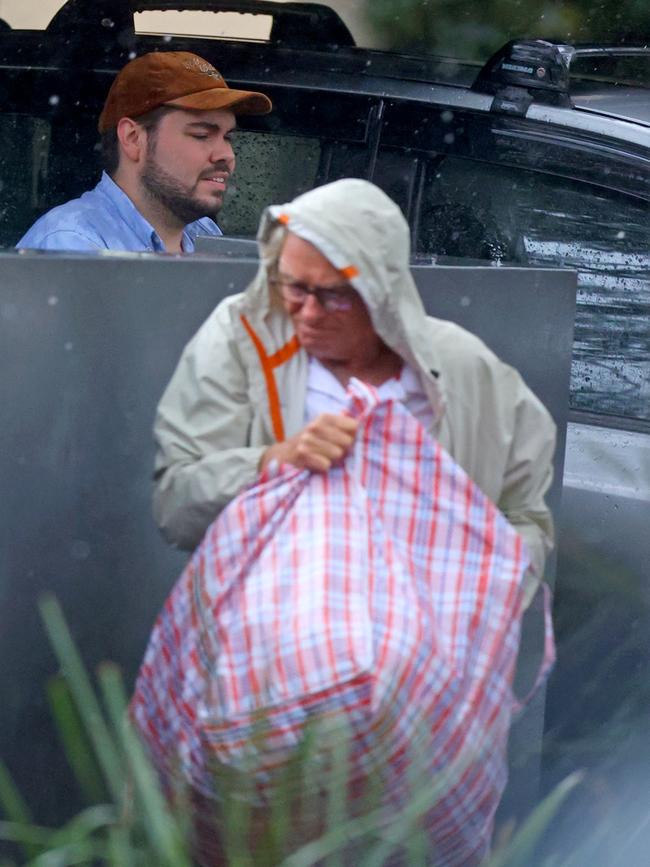 Bruce Lehrmann is seen being helped by his friend, sailor Rob Porter, as he moved into his new home. Picture: KHAPBM/Backgrid for news.com.au