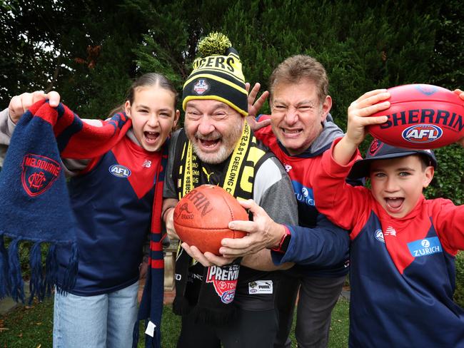 Melbourne Demons fans Alexis 11, Barry Helfenbaum and James 9 with AFLFA president Ron Issko. Picture: David Caird