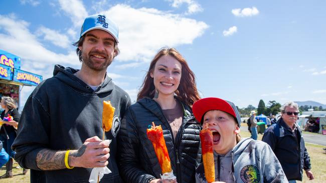 Hobart, Tasmania. Royal Hobart Show, Friday 27th October 2023. Jay Wooley, Meg Sullivan and Damian Faulds enjoying their Dagwood dogs at the Royal Hobart Show. Picture: Linda Higginson