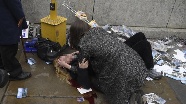 A woman lies injured on Westminster Bridge in London. Pictures: REUTERS/Toby Melville