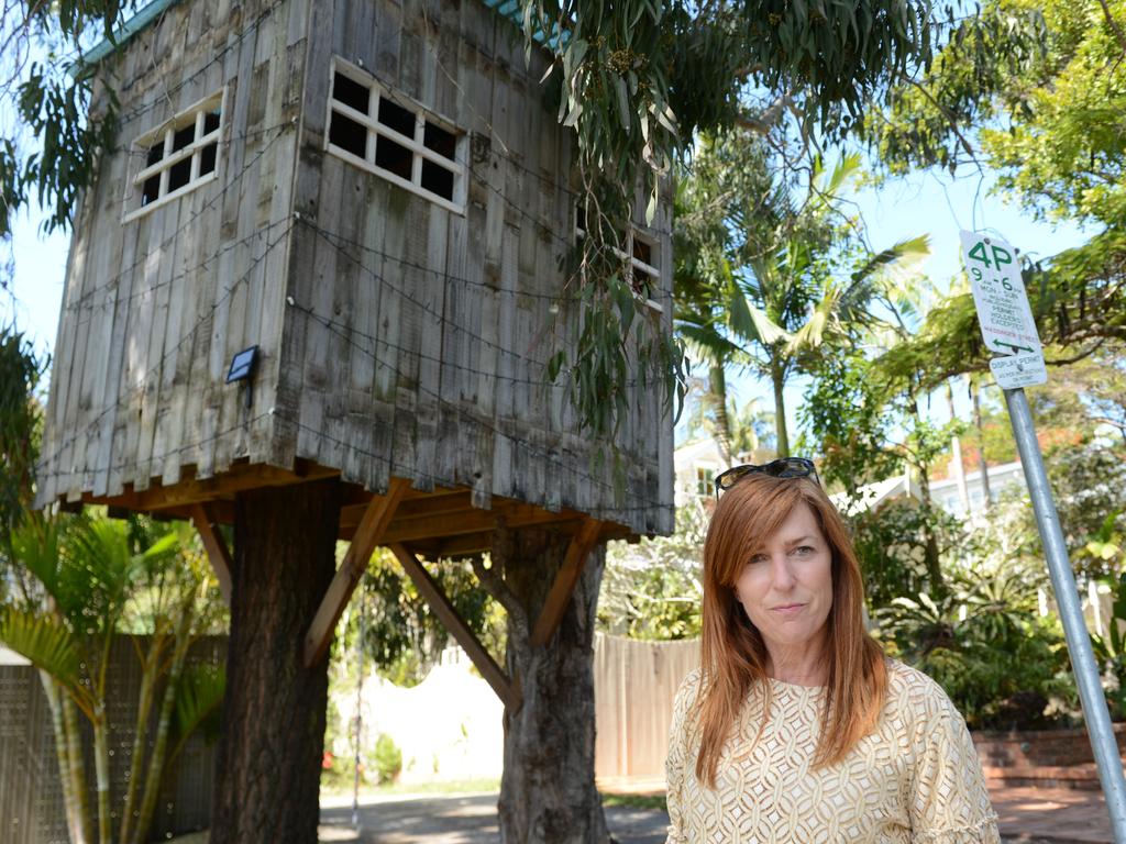 Byron Bay mother Mellanie Coppin with the treehouse outside her home. A lease for the use of the road reserve area will go back before Byron Shire Council but the council has recommended its removal. Picture: Savannah Pocock