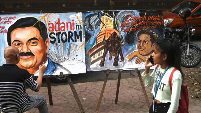 Art school teacher Sagar Kambli gives final touches to a painting of Indian businessman Gautam Adani highlighting the ongoing crisis of the Adani group in Mumbai on February 3.