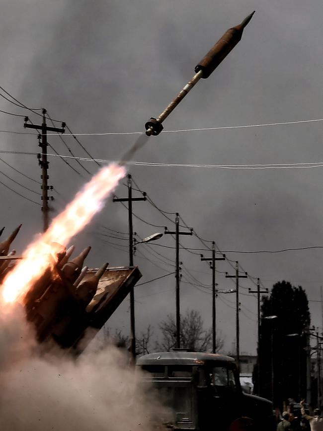 Iraqi government forces fire a rocket towards Islamic State (IS) group positions in west Mosul on March 14, 2017. Picture: AFP PHOTO / ARIS MESSINIS