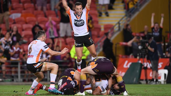 Luke Brooks celebrates Michael Chee Kam’s match winner. (AAP Image/Dave Hunt) 