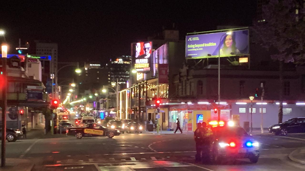 Police and ambulance crews at the scene on Hindley Street on Friday. Picture: George Yankovich