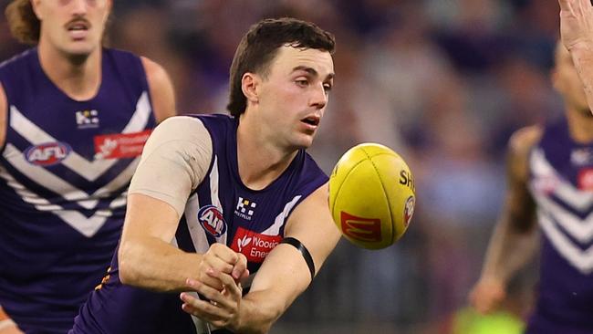 PERTH, AUSTRALIA - MAY 08: Jordan Clark of the Dockers handballs during the round nine AFL match between Fremantle Dockers and Collingwood Magpies at Optus Stadium, on May 08, 2025, in Perth, Australia. (Photo by Paul Kane/Getty Images)