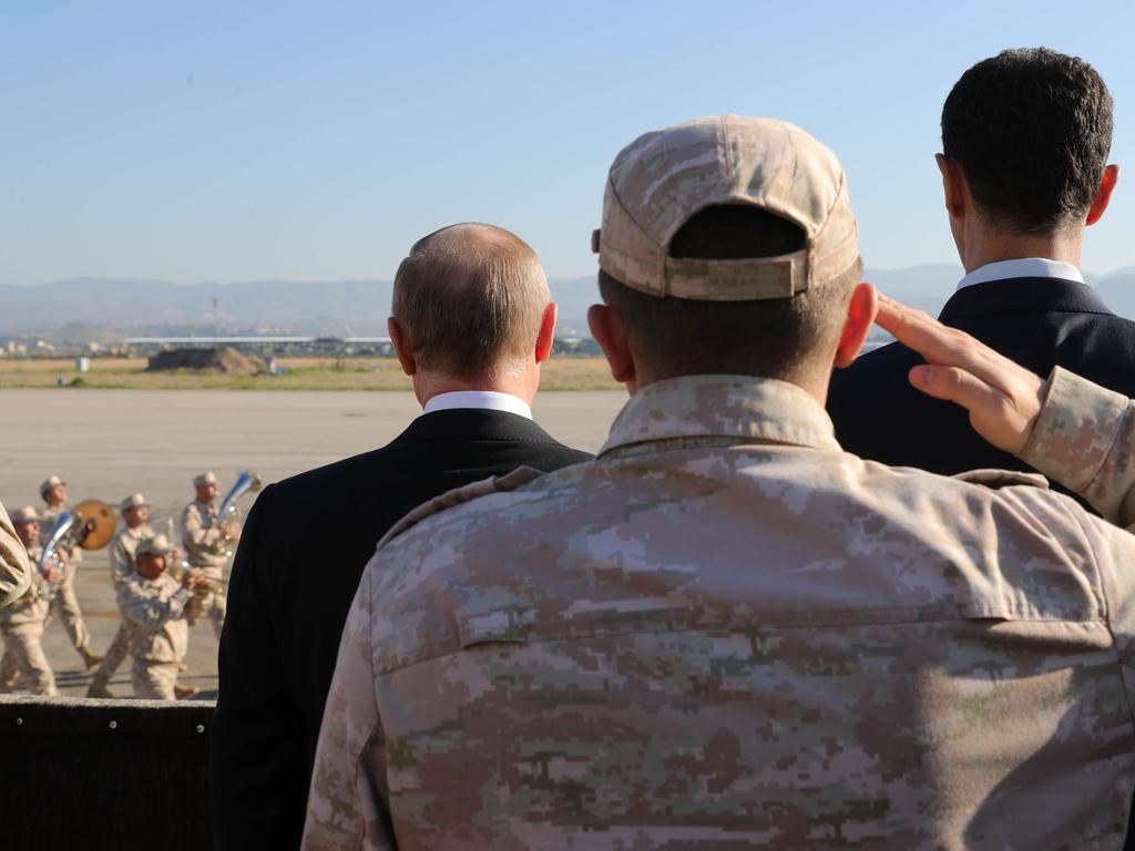 Russian President Vladimir Putin, left, and President of Syria Bashar al-Assad, right, inspect arriving troops at the Russian air base in Hmeimim in the northwestern Syrian province of Latakia. A similar intervention may soon happen in Venezuela. Picture: AFP