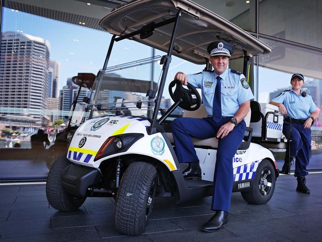 Superintendent Martin Fileman, Commander of Sydney City Police Area Command and Constable Amelia Wilkinson pictured in Darling Harbour with the new police golf cart. Picture: Sam Ruttyn