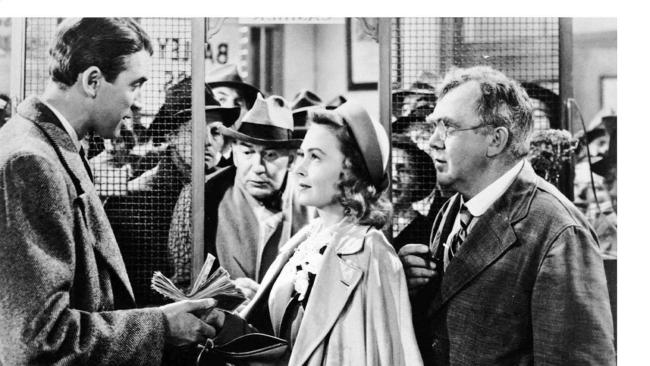 Jimmy Stewart, Donna Reed and Thomas Mitchell in a scene from It's A Wonderful Life.