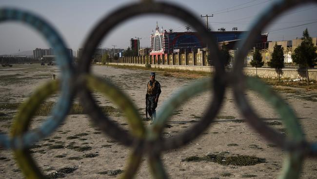 An Afghan policeman stands guard near the site of suicide bomb attack on the proximity of the Kabul International Cricket ground in Kabul. Picture: AFP PHOTO / WAKIL KOHSAR