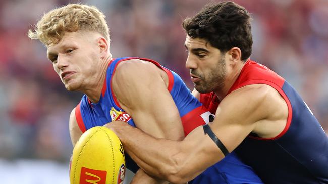 Christian Petracca tackles the Western Bulldogs Adam Treloar at the MCG in Round 1 at the MCG. Picture: Michael Klein