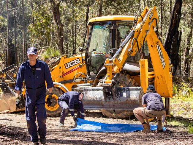 Police bring an excavator to search for the missing campers. Picture: Jason Edwards