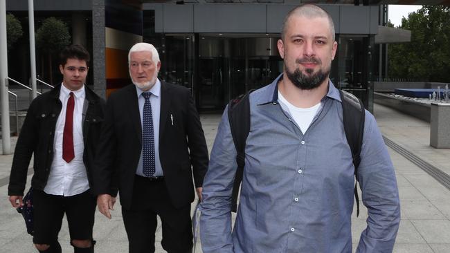 Far-right activist Neil Erikson, right, leaves the Federal Court in Melbourne. Picture: AAP