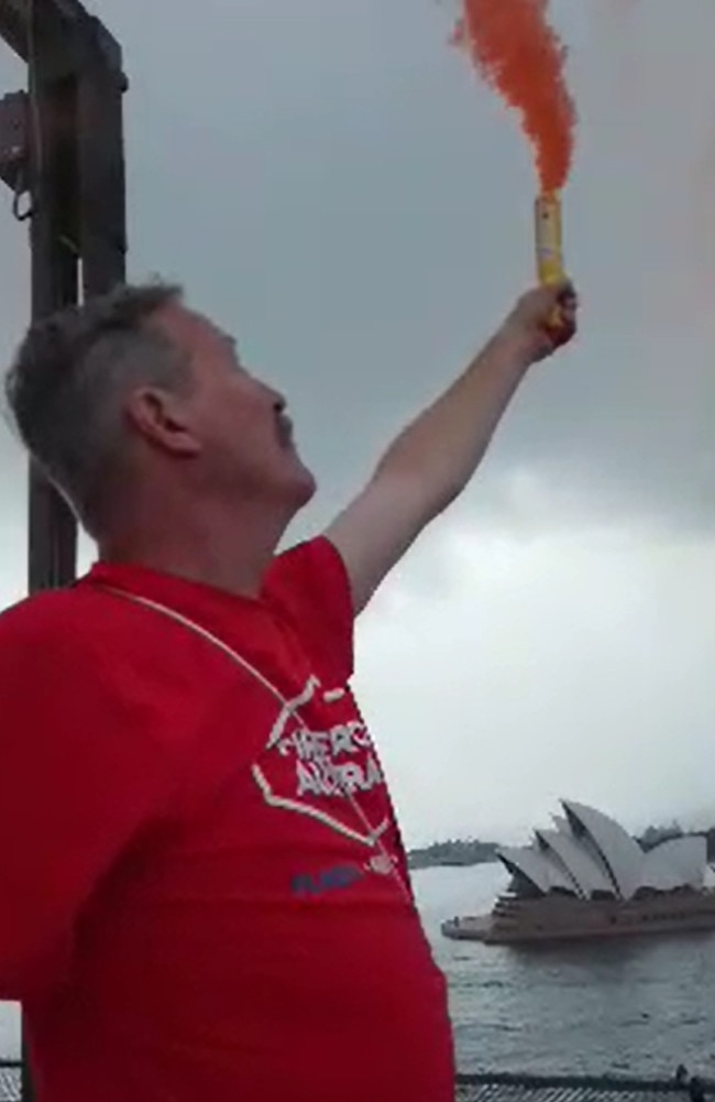 Alan Glover holding up a flare during the protest.