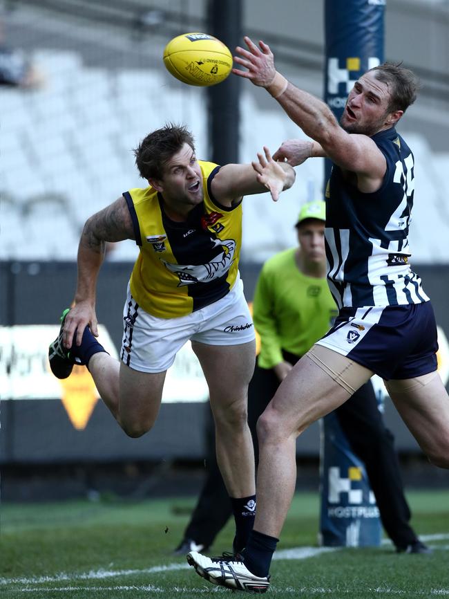 Geelong FNL’s Luke Delaney spoils MPNFL forward Tim Bongetti.