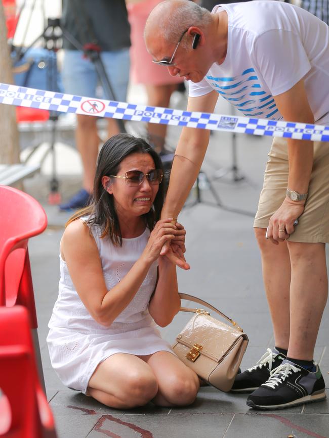 Mr Ledinh’s close friend Vivian Vo broke down in tears on the bloodstained footpath outside the cafe where he was killed. Picture: John Grainger