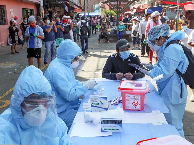 Health workers carry out COVID-19 tests at a street market in Peru. Picture: Ministerio De Defensa Del Peru