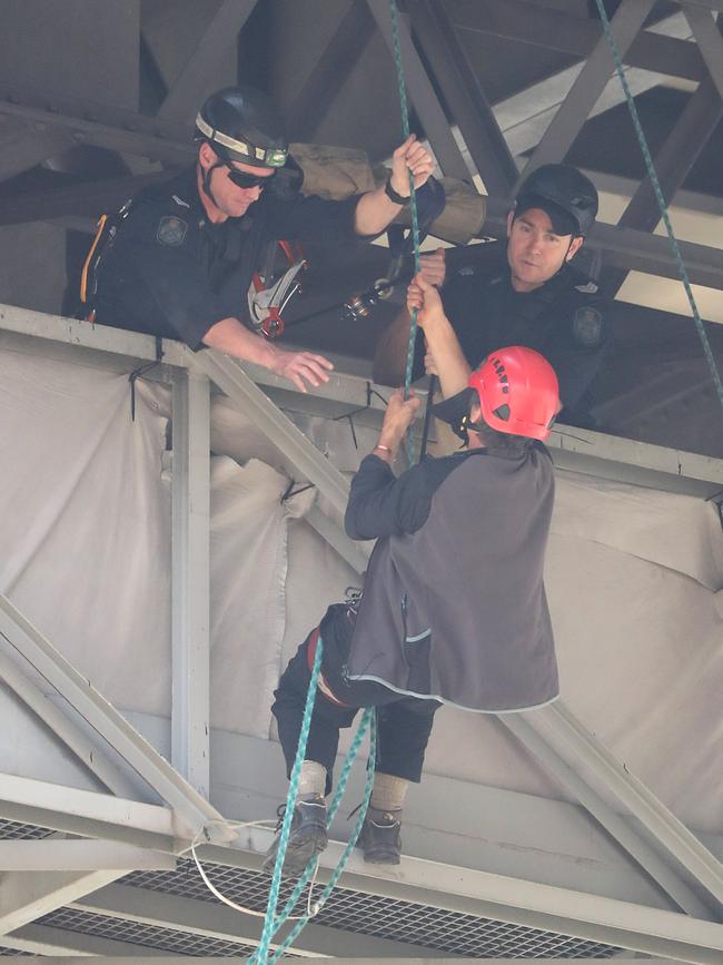 Extinction Rebellion protester Paul Jukes suspended himself from the Story Bridge in Brisbane. Picture: Peter Wallis