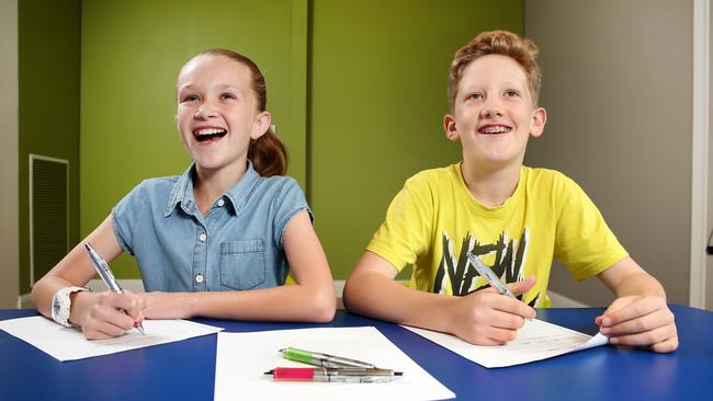 Summer Tuckey, 11, and Felix Griebe, 10, practice their handwriting. Picture: Richard Dobson