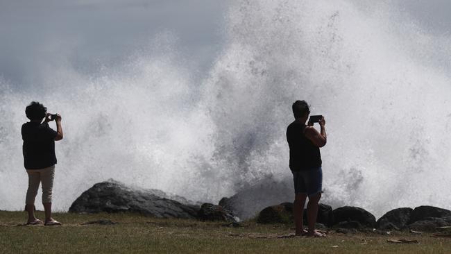 People watch the waves at Point Dangeras Cyclone Oma inched closer. (Photo by Chris Hyde/Getty Images)