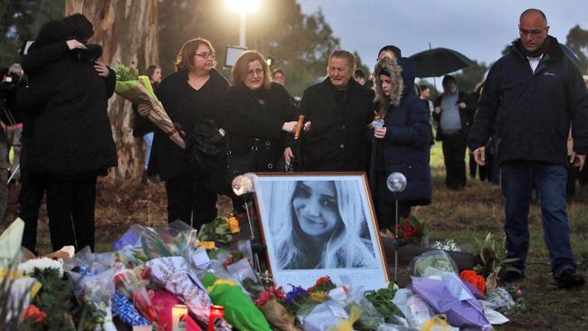 Family and mourners at a candlelight vigil in at the site where Courtney Herron was found dead. Picture: Aaron Francis