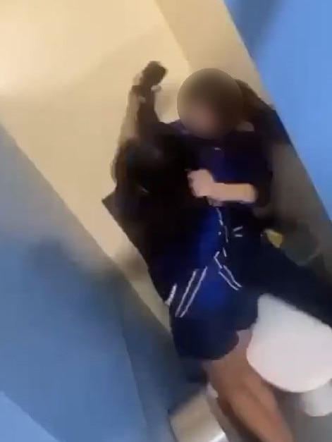 The students were fighting inside a toilet cubicle.