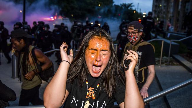 A woman is pepper sprayed at the Colorado State Capitol as protests against the death of George Floyd continue for a third night. Picture: AFP