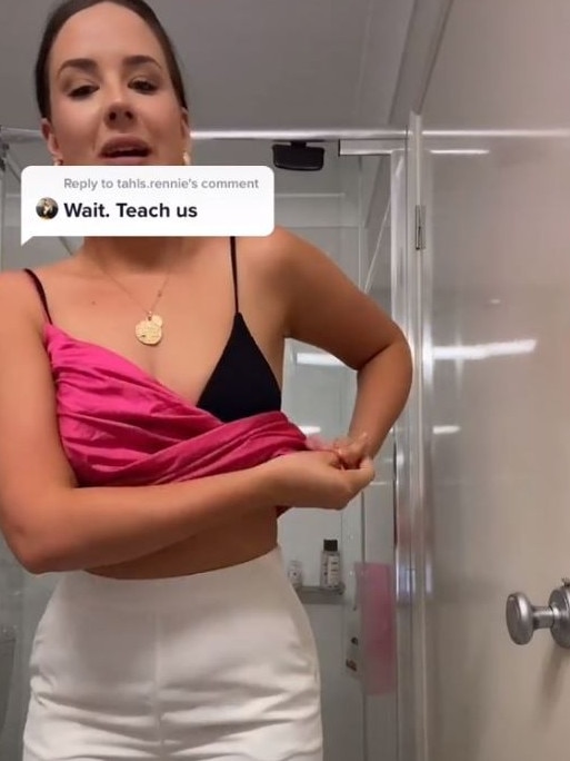 Laura shows how to loop the strap into your top and out the bottom before pulling back over your shoulder. Picture: TikTok/ellogawjuzz