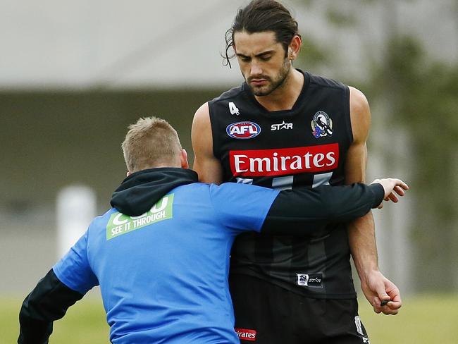 Nathan Buckley gives Brodie Grundy some tackling tips at Collingwood training. Picture: Colleen Petch