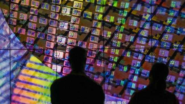 Visitors to the TSMC Renovation Museum in Hsinchu, Taiwan, view a wafer display. Picture: AFP