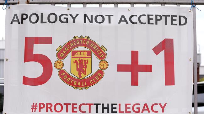 A placard advocates the German model, where fans hold 51 per cent of voting rights