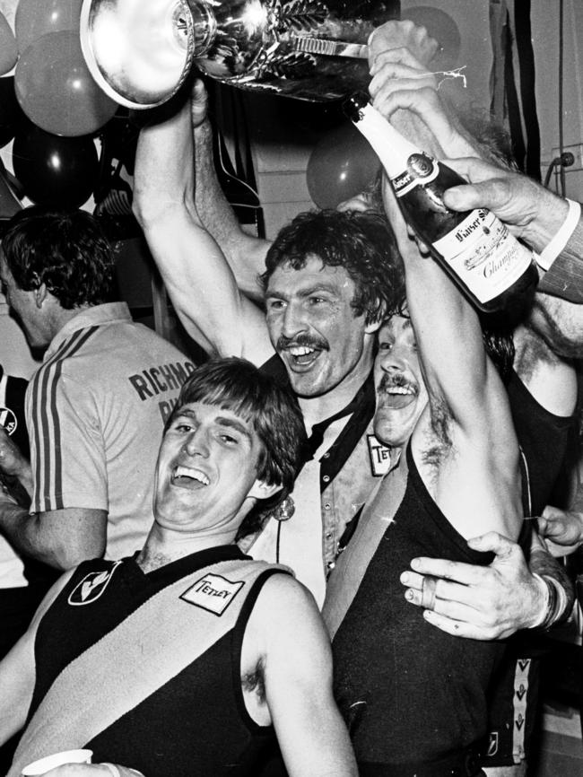 Malthouse in the rooms with the premiership cup.