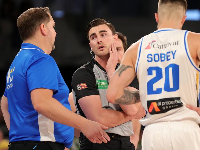 Justin Schueller, coach of the Bullets speaks with a referee during the round four NBL match between South East Melbourne Phoenix and Brisbane at John Cain Arena. Photo: Kelly Defina/Getty Images.