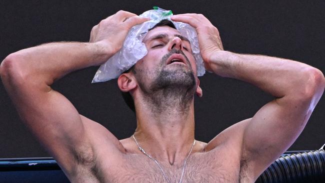 Djokovic toughed it out in hot conditions to reach the final four. (Photo by WILLIAM WEST / AFP)