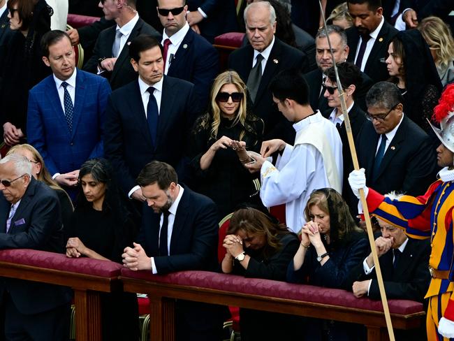 A priest gives communion to US Secretary of State Marco Rubio's wife Jeanette during a Holy Mass for the Beginning of the Pontificate of Pope Leo XIV, in St Peter's square. Picture: AFP