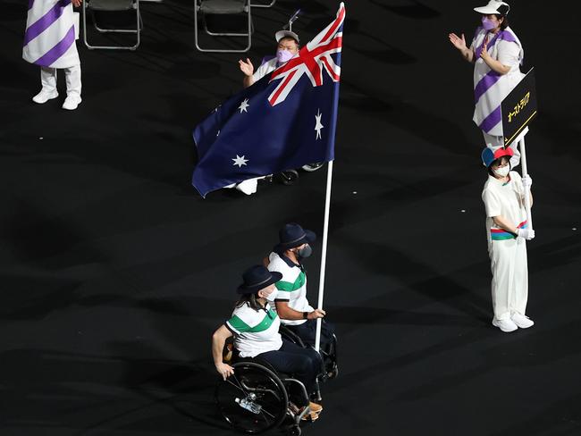 Danni Di Toro and Ryley Batt carry the Aussie flag.