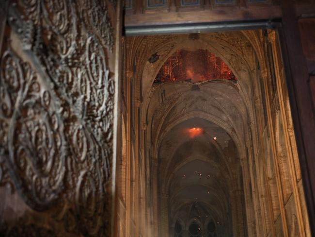 Smoke and flames are seen in the interior of Notre Dame cathedral in Paris, Monday, April 15, 2019. (Philippe Wojazer/Pool via AP)