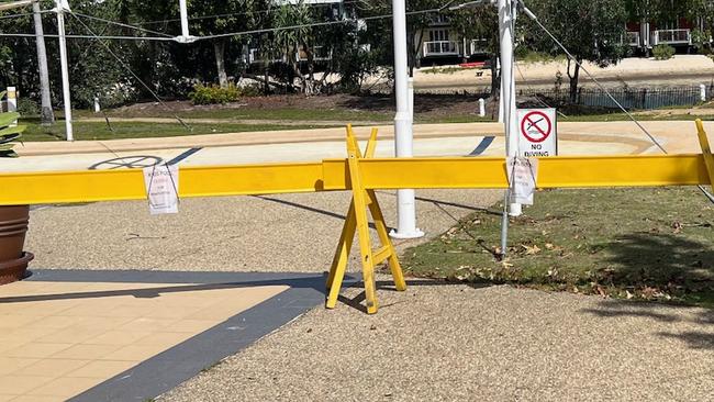 Signs and barricades around an empty pool at Couran Cove Island Resort.