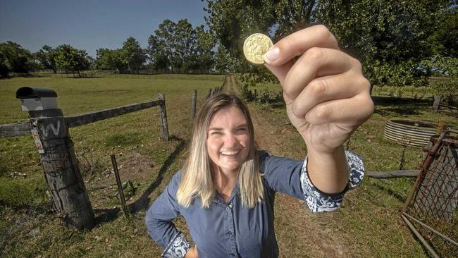 Farrell and McCrohon Rural Sales Specialist Jojo Newby with as much money as it will take for you to have a legitimate bid on a piece of rural property on Carrs Creek, the proceeds will go to charity. Picture: Adam Hourigan