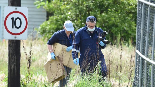 Forensic police examine the scene. Picture: Lawrence Pinder