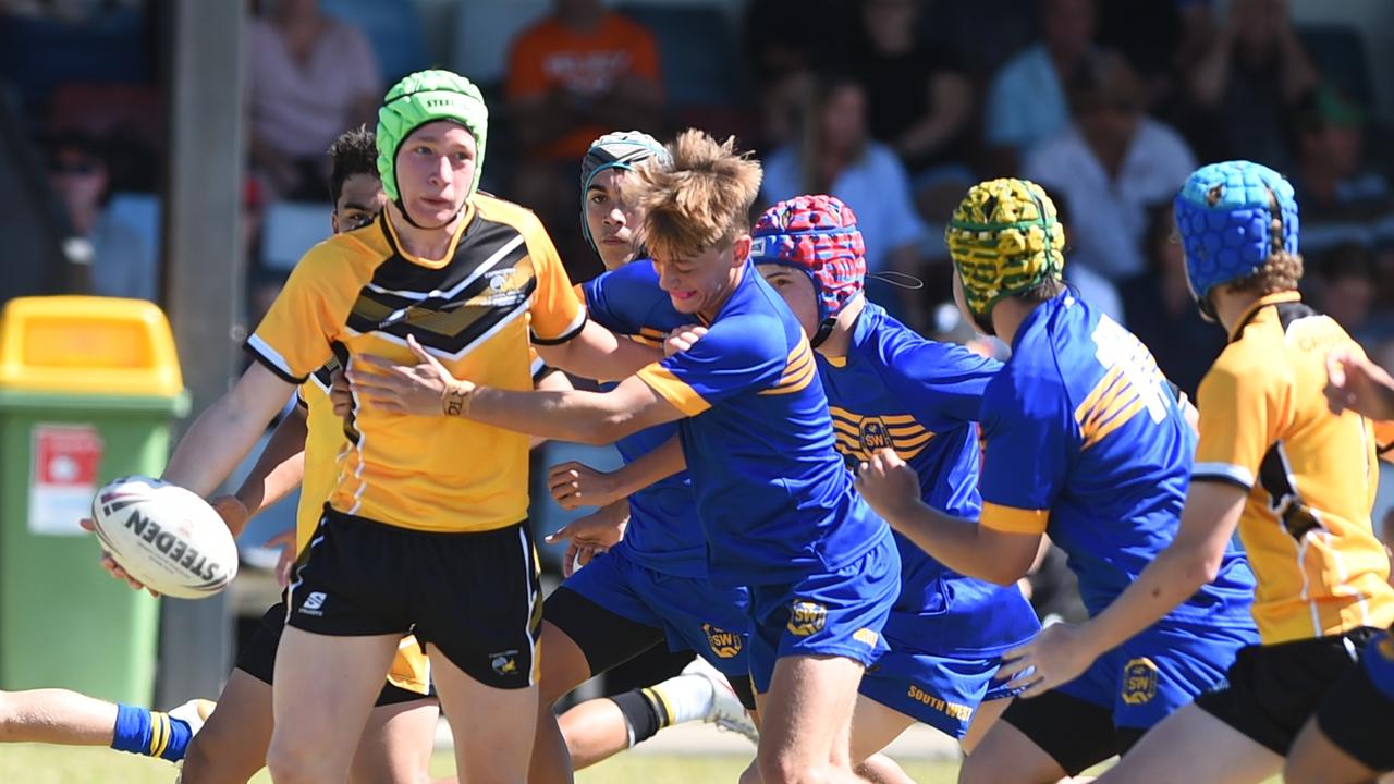 Boys Rugby League State Championship held at Northern Division, Brothers Leagues ground, Townsville. 14-15 years. Capricornia (gold) v South West (blue). Parker Gallagher of The Cathedral College, Rockhampton.