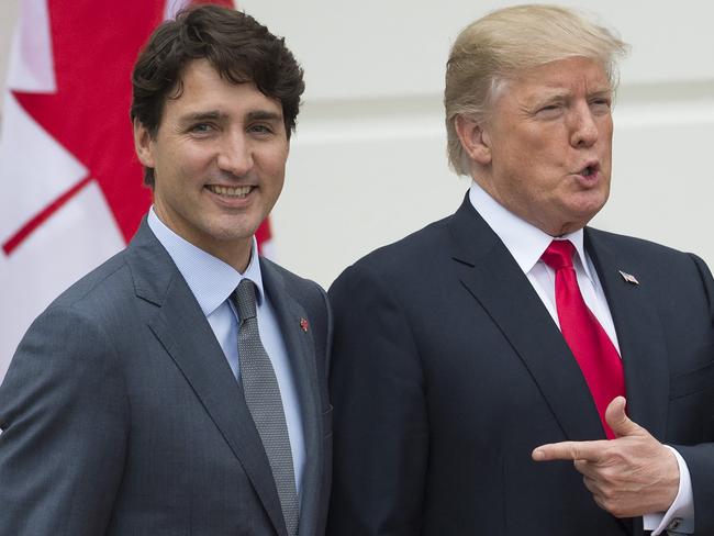 (FILES) US President Donald Trump (R) welcomes Canadian Prime Minister Justin Trudeau at the White House in Washington, DC, on October 11, 2017. Canada was scrambling on November 26, 2024, to blunt the impact of US President-elect Donald Trump's threat to implement steep tariffs once he takes office, as experts warned of a potentially "catastrophic" hit to the Canadian economy. (Photo by SAUL LOEB / AFP)