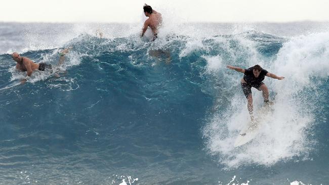 Surfers are seen at Snapper Rocks on the Gold Coast , Thursday February 21, 2019. Huge swells and high tides are set to pummelling south-east Queensland beaches over the coming days as Cyclone Oma tracks towards the Queensland coast. Photo: Dave Hunt/AAP.