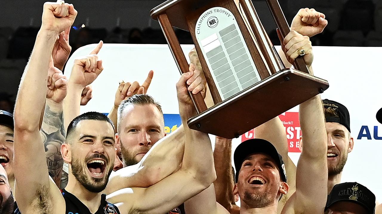 MELBOURNE, AUSTRALIA - JUNE 25: Chris Goulding and Mitch McCarron and the Melbourne United team celebrate victory with the trophy after game three of the NBL Grand Final Series between Melbourne United and the Perth Wildcats at John Cain Arena, on June 25, 2021, in Melbourne, Australia. (Photo by Quinn Rooney/Getty Images)