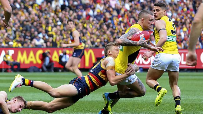 Hugh Greenwood tries to stop Norm Smith Medallist Dustin Martin. Picture: Sarah Reed