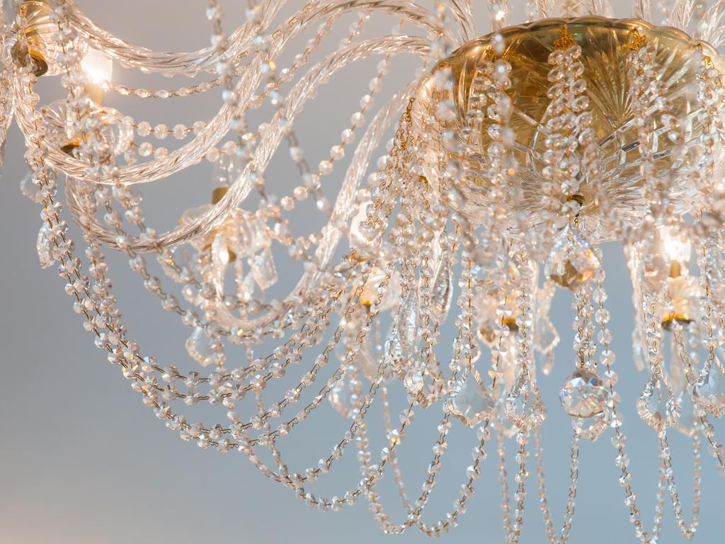 Shiny crystal glass decoration elements of a luxury chandelier.